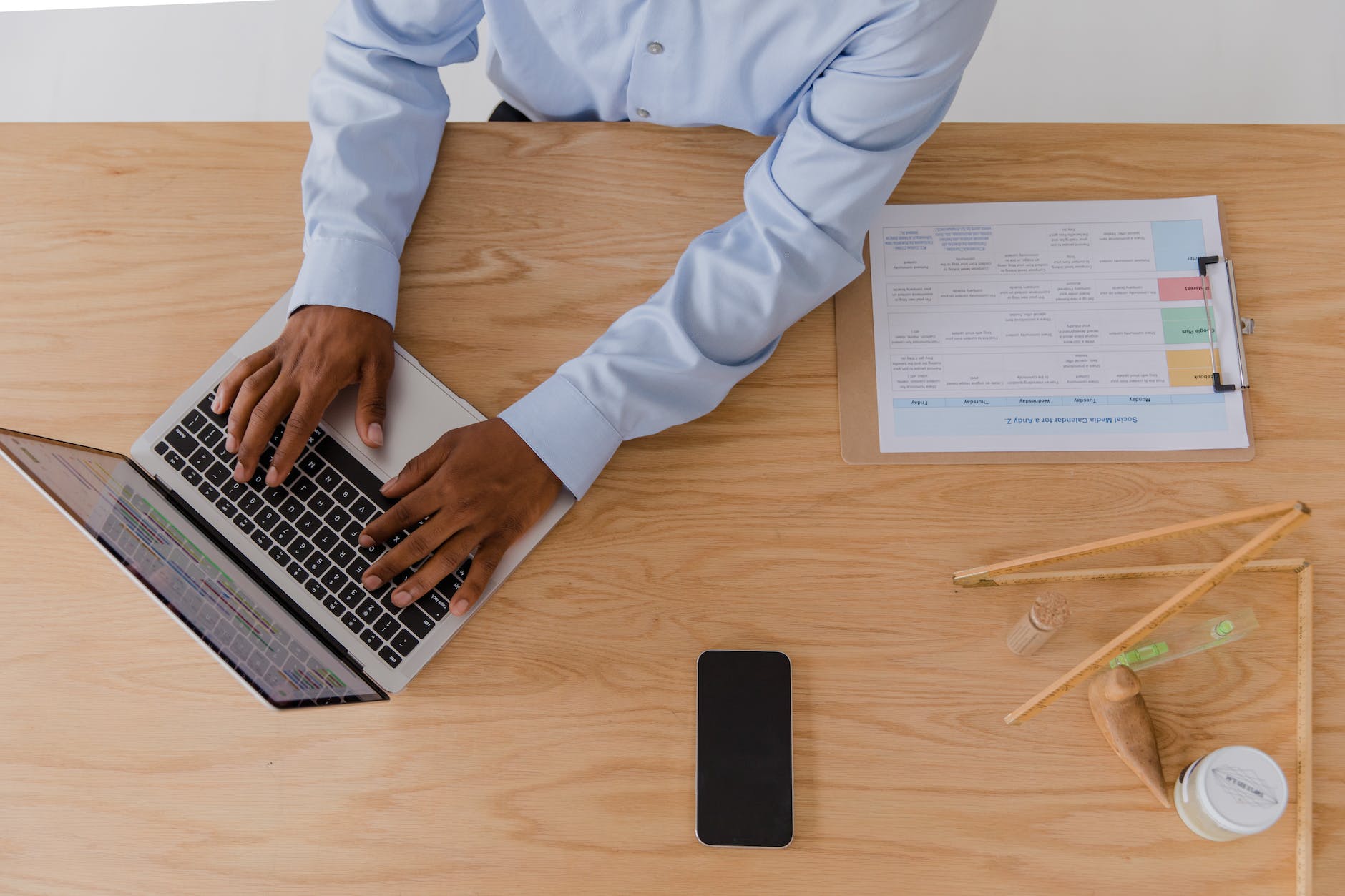 man using laptop while sitting at desk